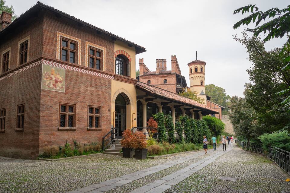 A historic building with a brick facade, arched windows, and a tower.