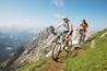 German Alps, Karwendel, young couple mountain biking