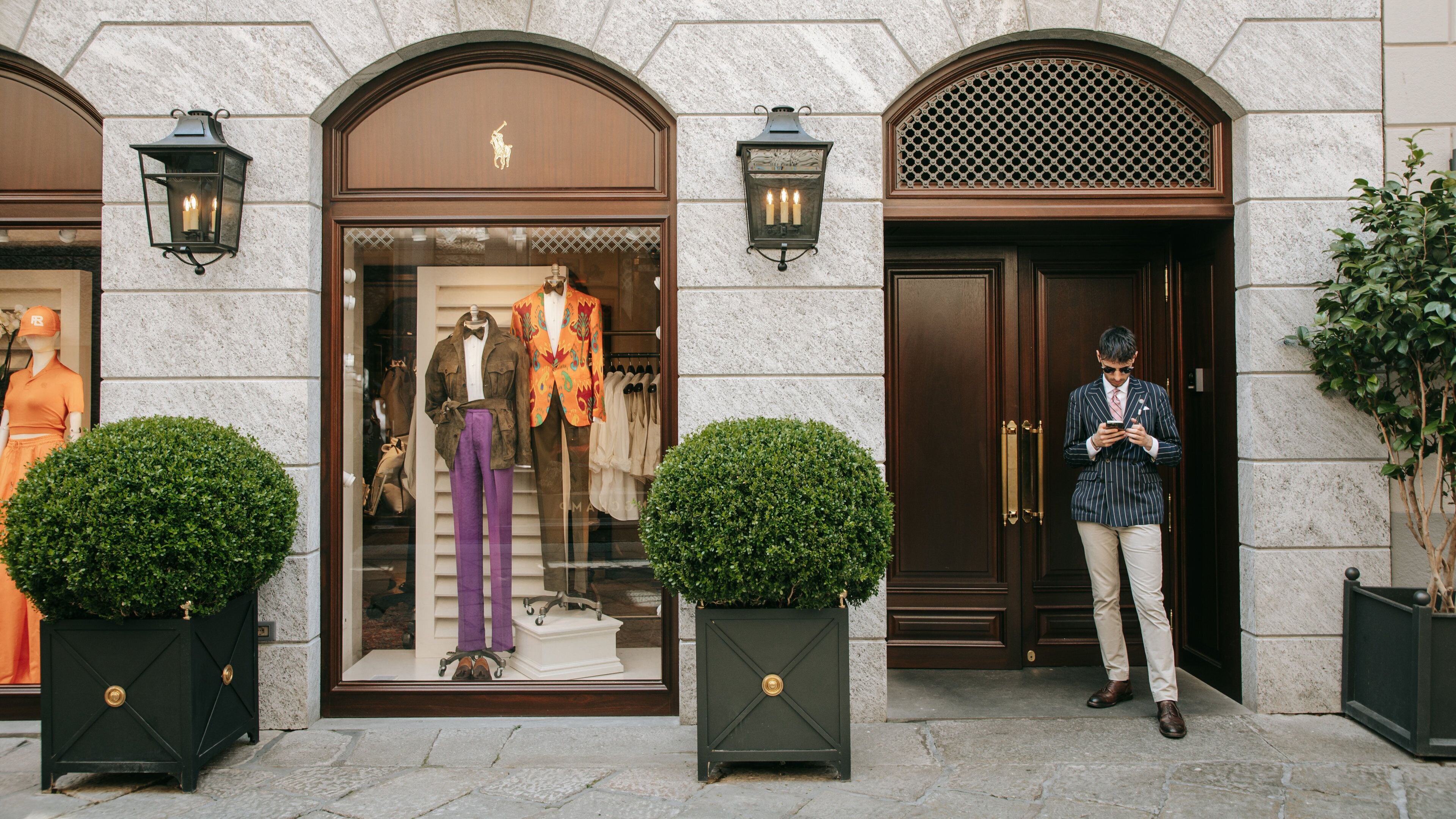 Milan Fashion District which includes shopping and street scenes as well as an individual male