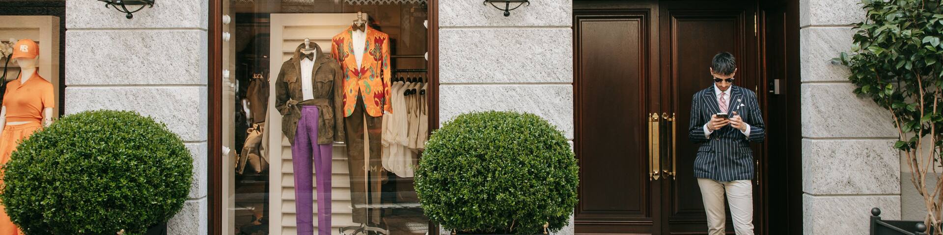 Milan Fashion District which includes shopping and street scenes as well as an individual male