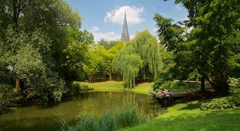 Botanical Gardens featuring a park and a lake or waterhole as well as a small group of people