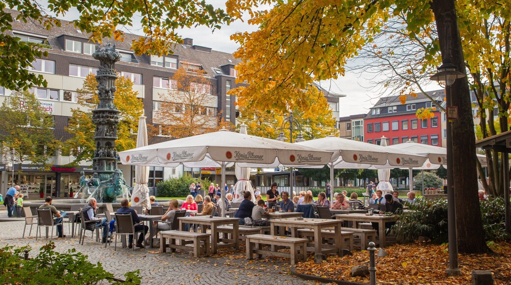 Gorresplatz featuring fall colors and outdoor eating as well as a small group of people