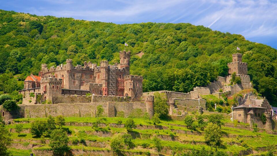 A medieval castle surrounded by lush green hills.