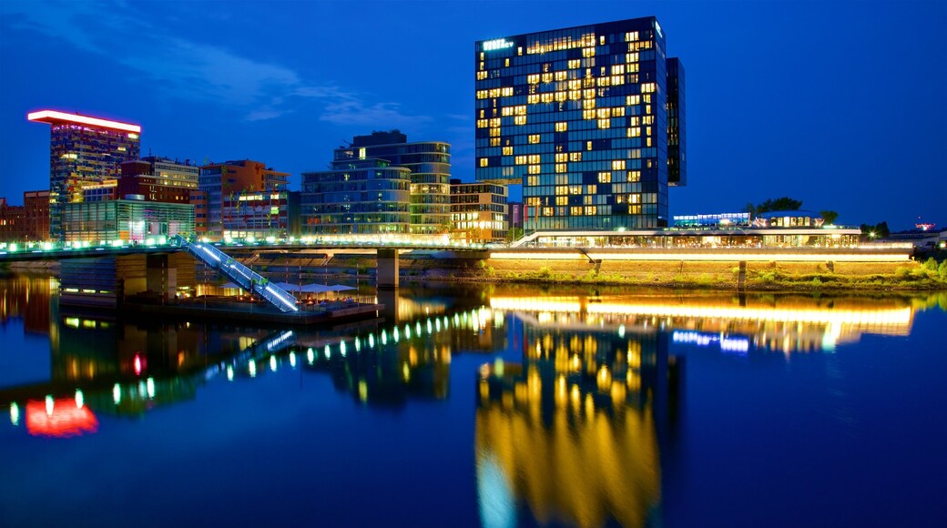Medienhafen which includes a city, night scenes and a river or creek