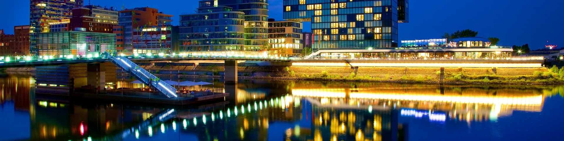 Medienhafen which includes a city, night scenes and a river or creek