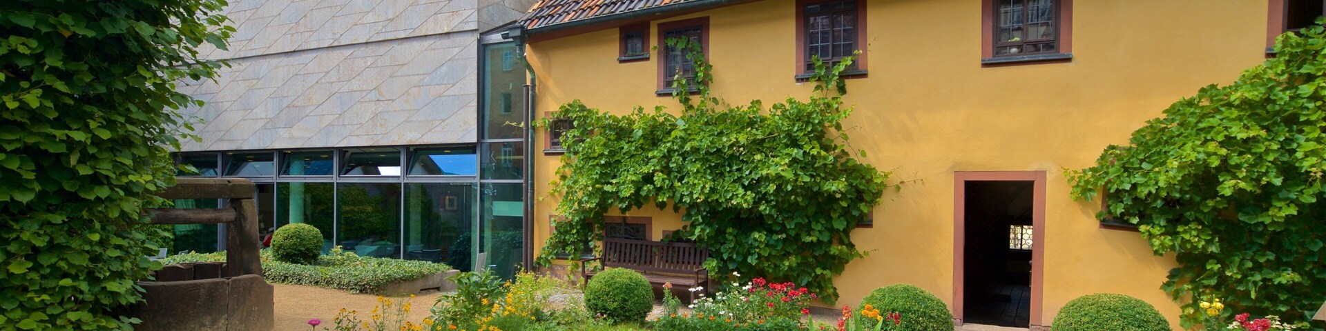 Bach House featuring a house, a park and wildflowers
