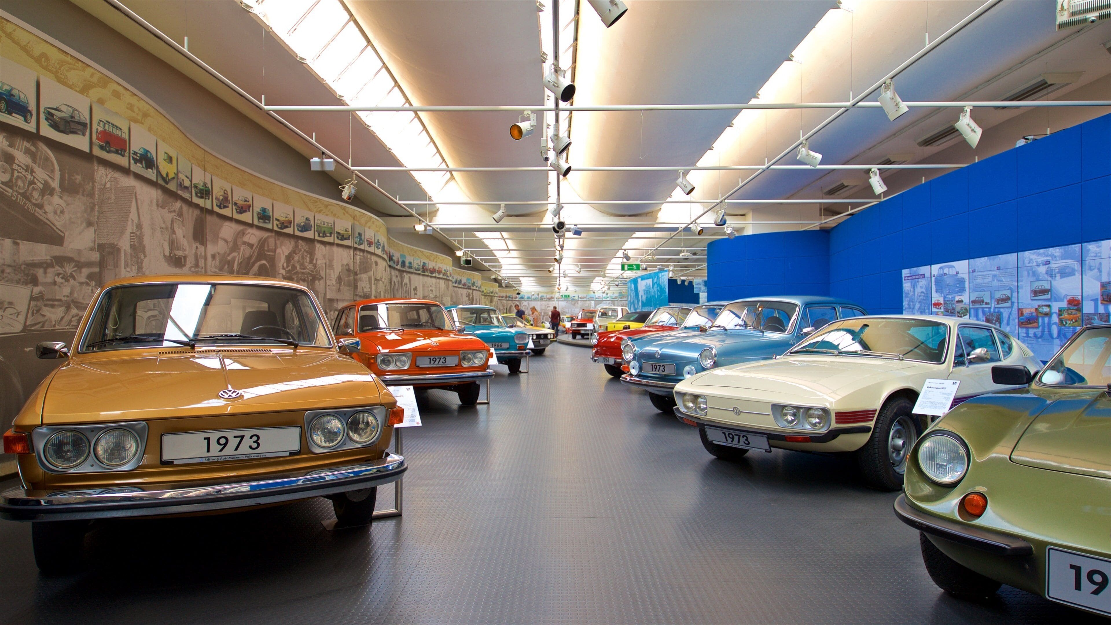 Un museo con auto d'epoca in mostra, tra cui una Volkswagen e una BMW del 1973.