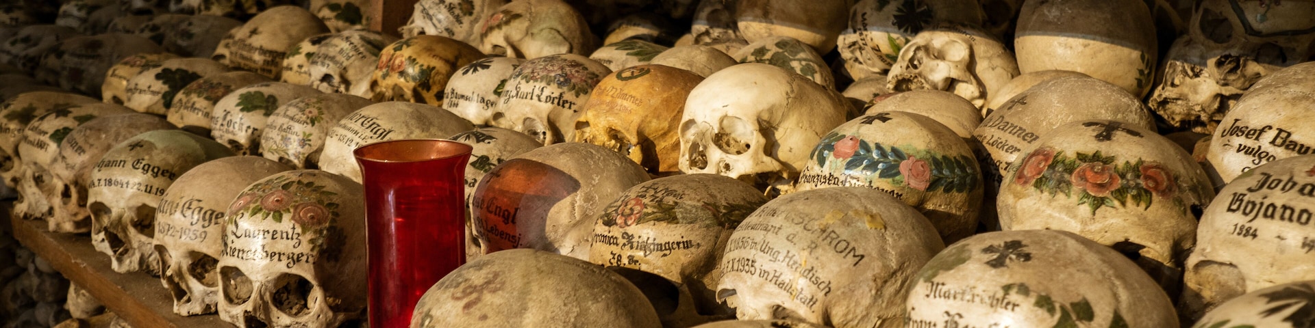 View of hundreds of painted skulls and bones inside the famous charnel house at the mountain village Hallstatt in the Salzkammergut region, Austria