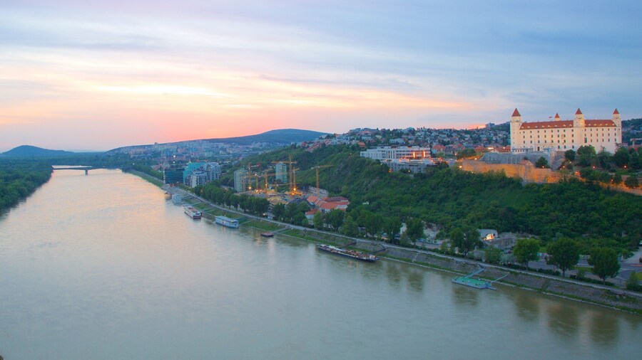 Bratislava showing a river or creek, a sunset and a city