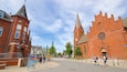 A historic church with a tall spire and a clock tower.