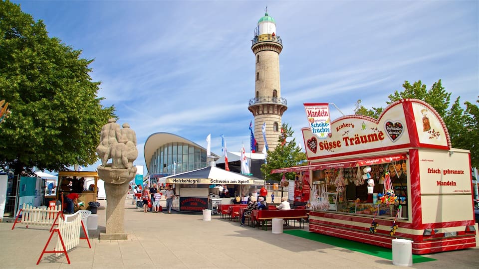 A street with a food stall, a mosque, and a modern building.
