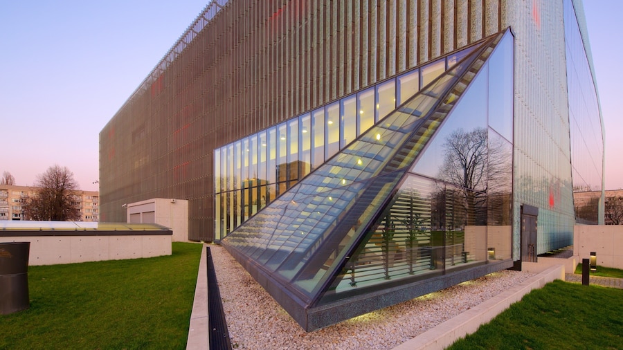 Warsaw which includes modern architecture and a sunset