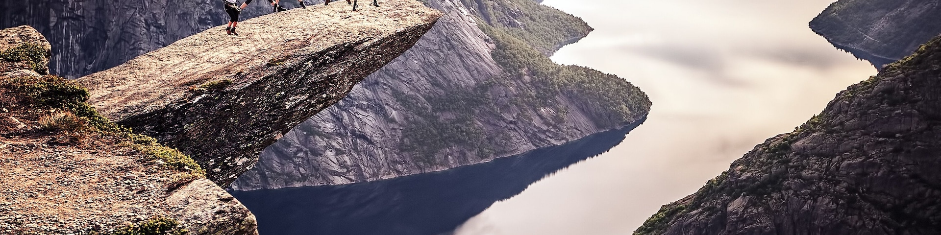 People on rocks harsh Norway, Trolltunga; Shutterstock ID 294975638