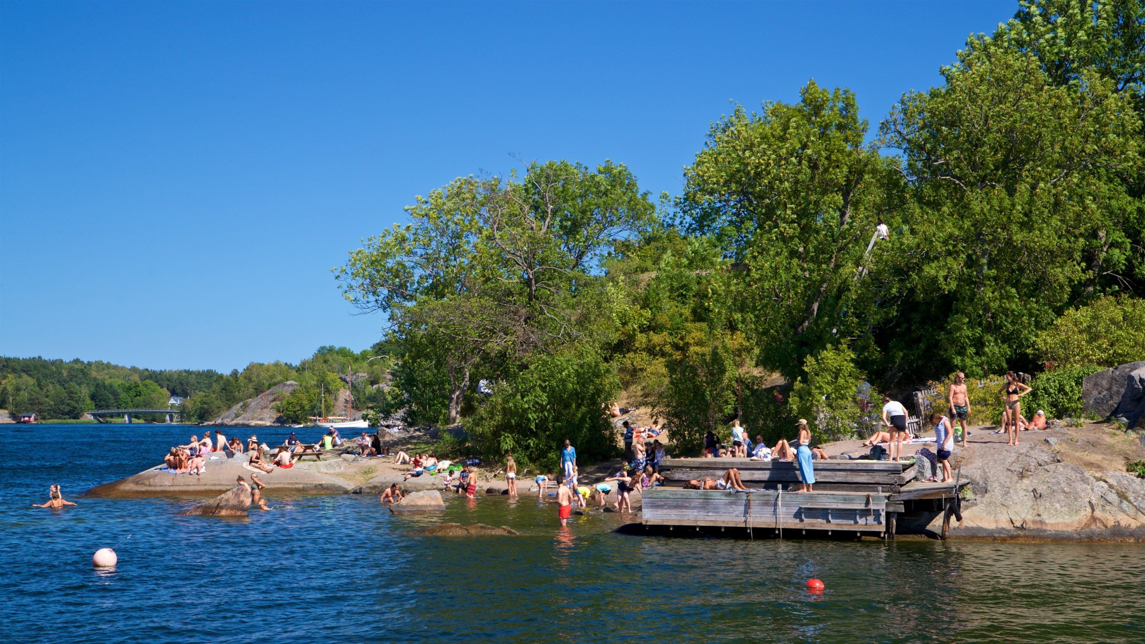 Battery Park showing a lake or waterhole as well as a small group of people