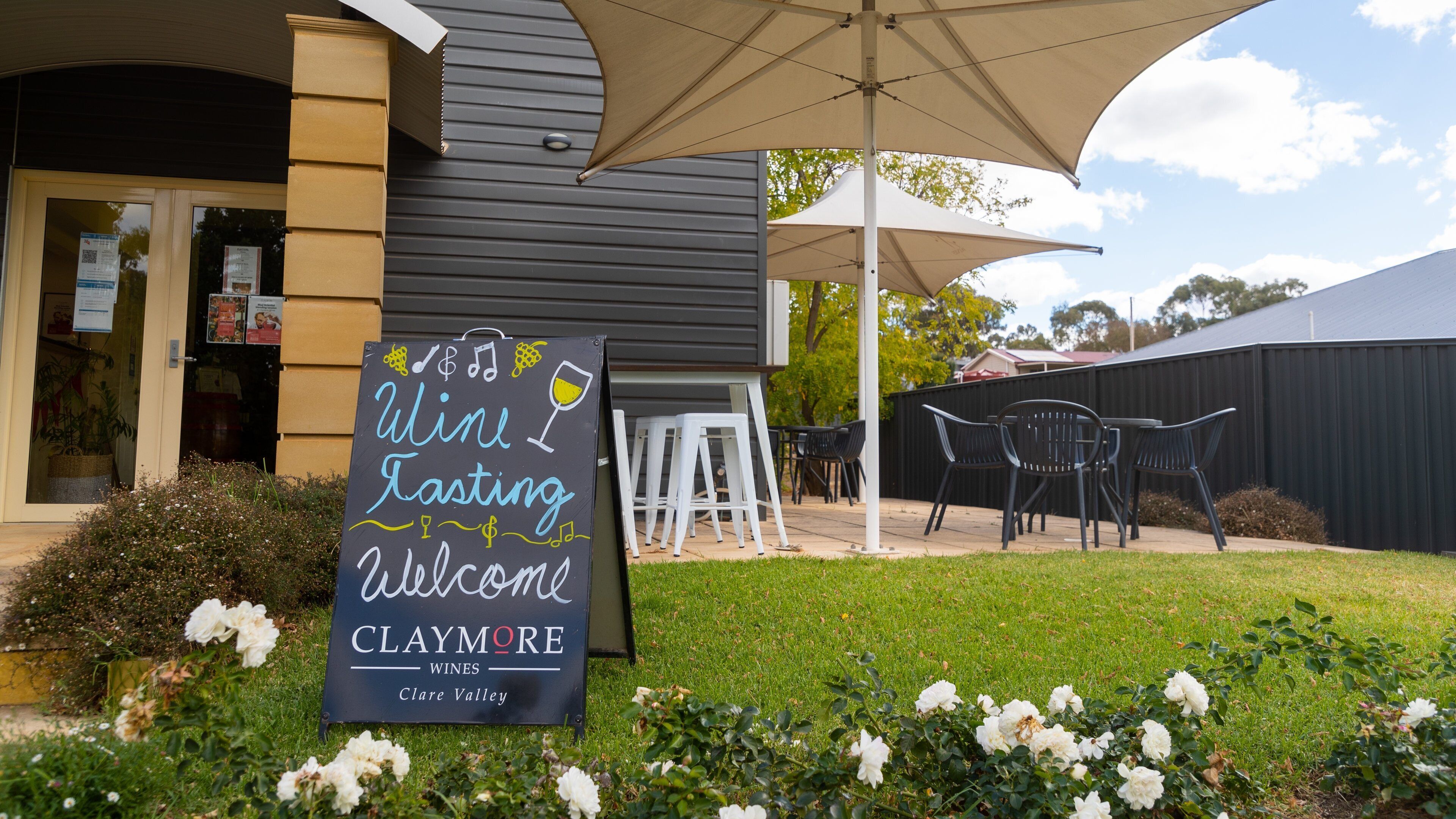 Claymore Wines featuring signage and wildflowers