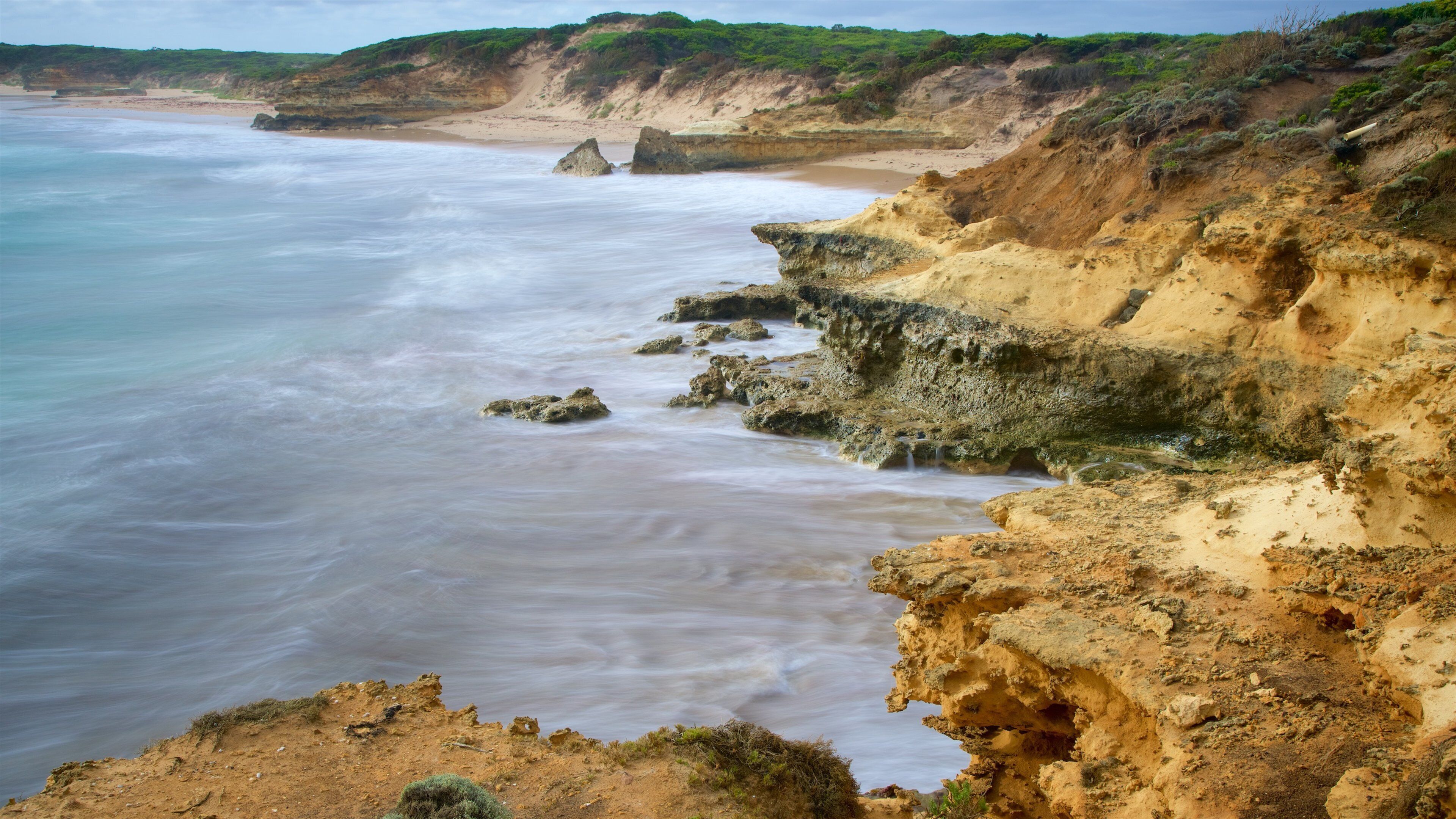 Peterborough featuring a sandy beach and rocky coastline