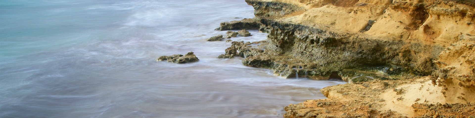Peterborough featuring a sandy beach and rocky coastline