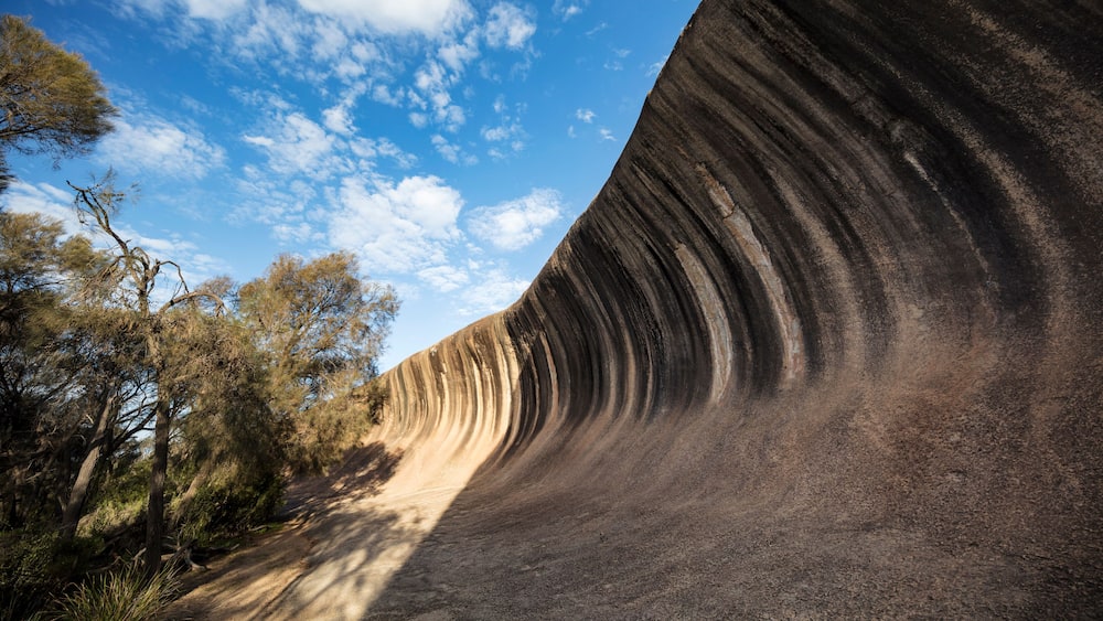 Wave Rock, a 15 metre high natural rock formation that is shaped like a tall breaking ocean wave and is located at Hyden in Western Australia