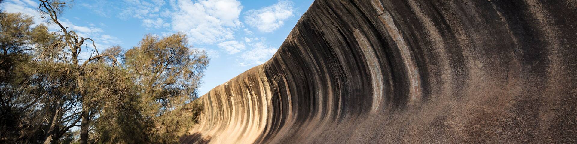 Wave Rock, a 15 metre high natural rock formation that is shaped like a tall breaking ocean wave and is located at Hyden in Western Australia