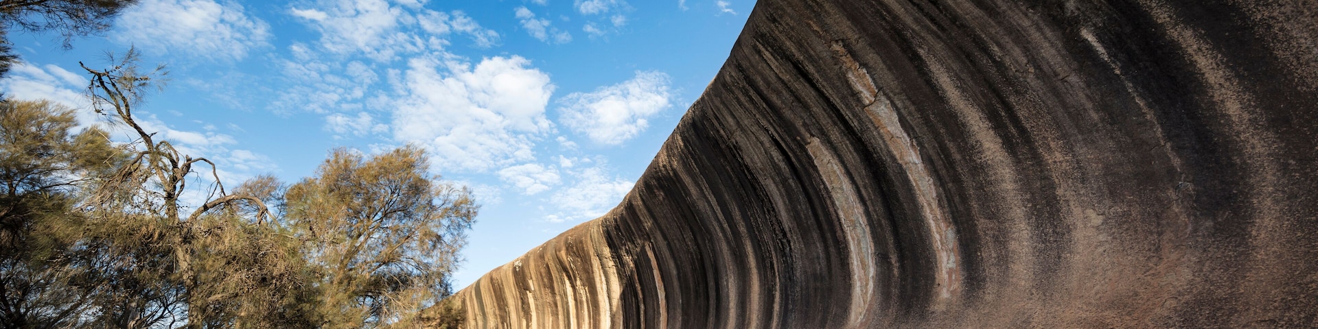 Wave Rock, a 15 metre high natural rock formation that is shaped like a tall breaking ocean wave and is located at Hyden in Western Australia