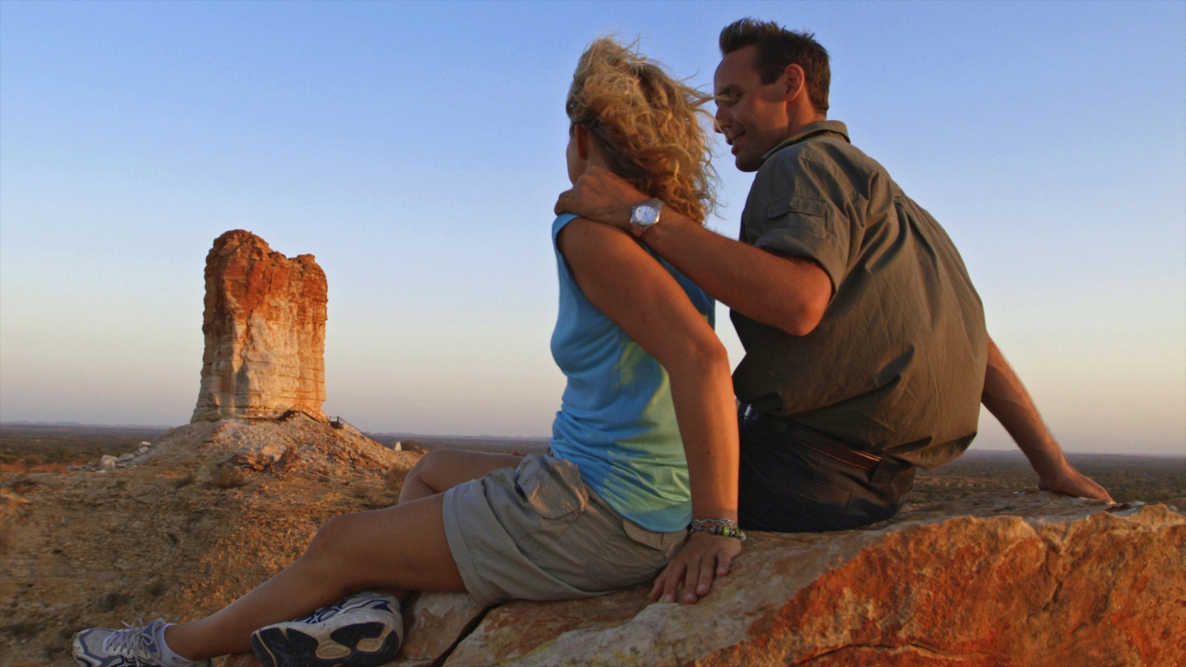 Chambers Pillar which includes a sunset, desert views and a gorge or canyon
