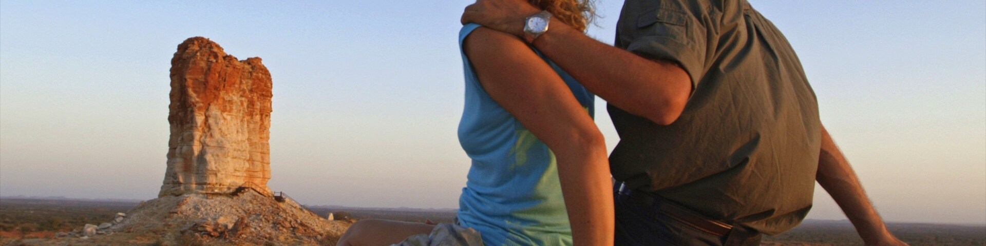 Chambers Pillar which includes a sunset, desert views and a gorge or canyon