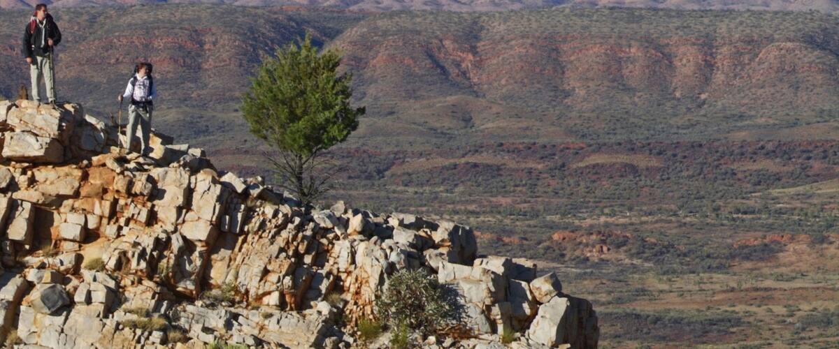 Larapinta Trail Trailhead which includes hiking or walking and tranquil scenes as well as a small group of people