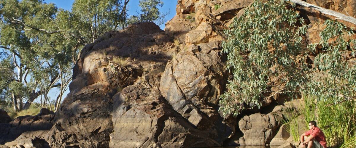 Alice Springs featuring a lake or waterhole as well as an individual male