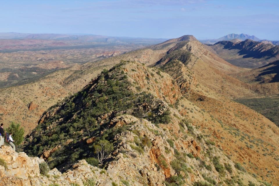 A rugged mountain landscape with rocky terrain and sparse vegetation.