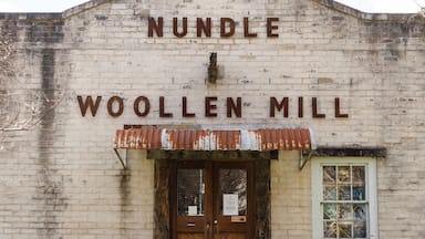 A weathered building with the sign "NUNBLE WOOLLEN MILL".