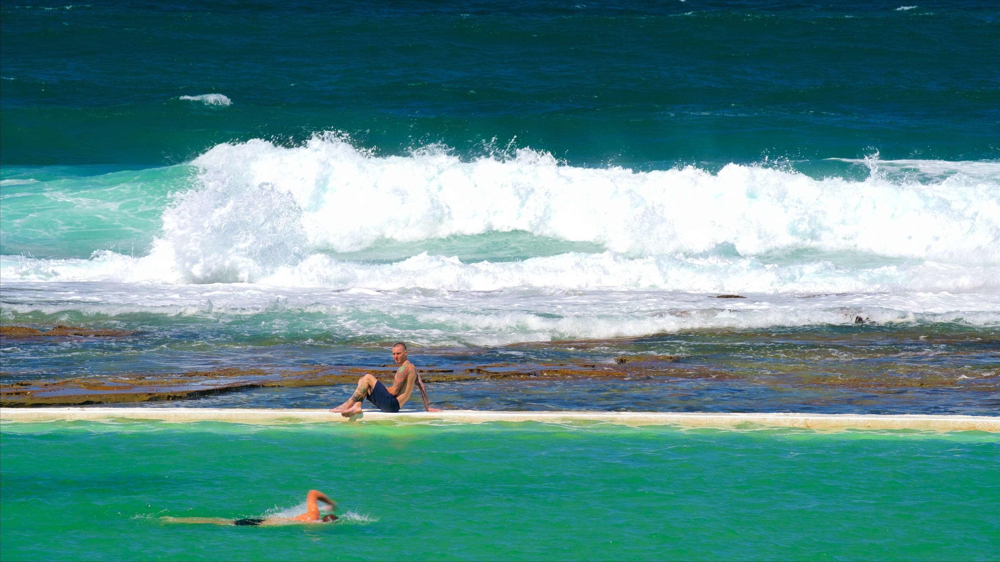 Newcastle featuring a bay or harbor, a pool and rugged coastline