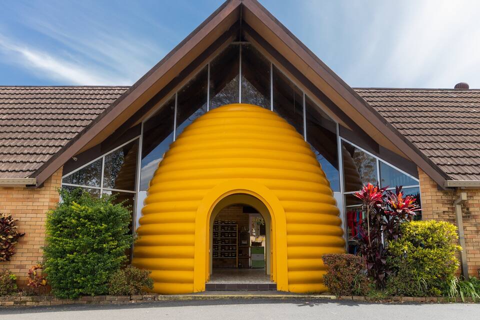 A building with a yellow archway and a brown roof.