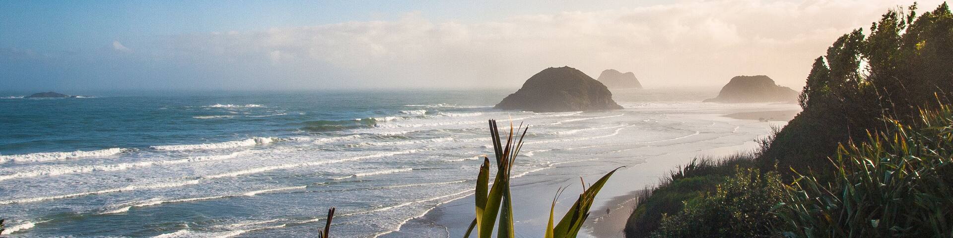 Sunrise over the rocks of the Back beach in New Plymouth, New Zealand. Perfect spot for surfing.; Shutterstock ID 580134319; Purchase Order: -