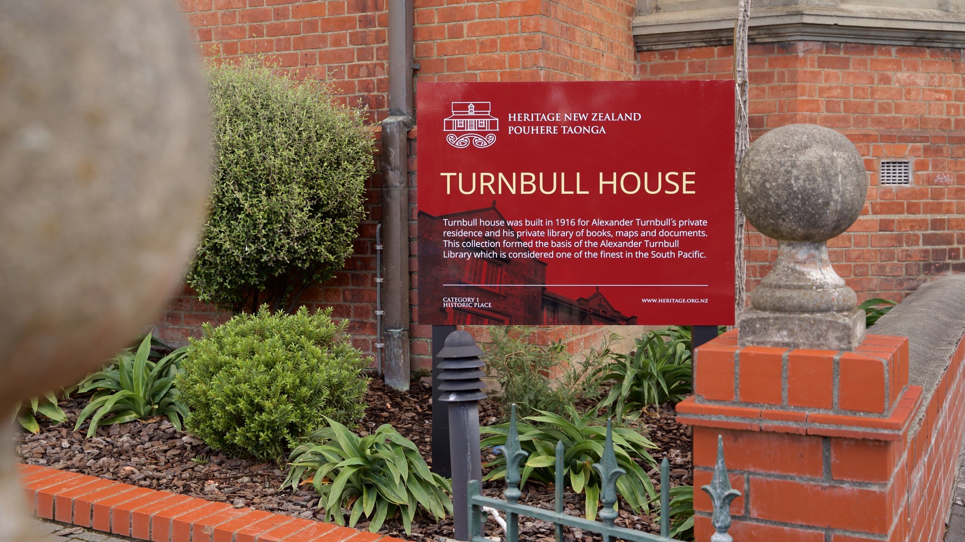 Turnbull House showing a garden and signage
