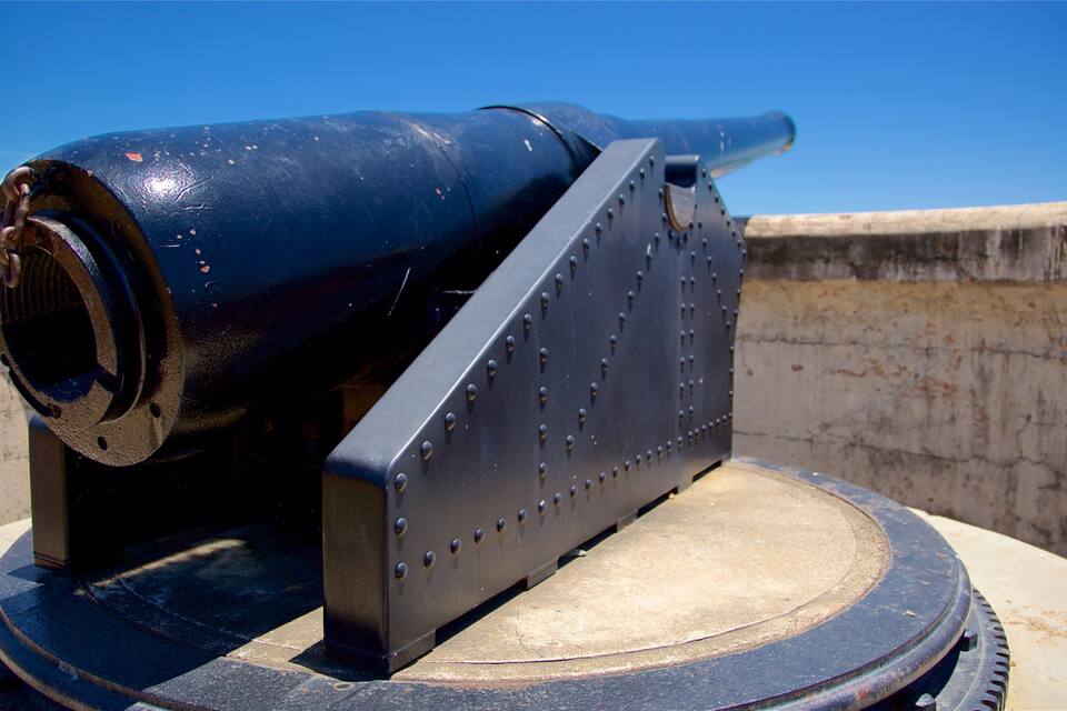 A cannon on a platform with a clear blue sky in the background.