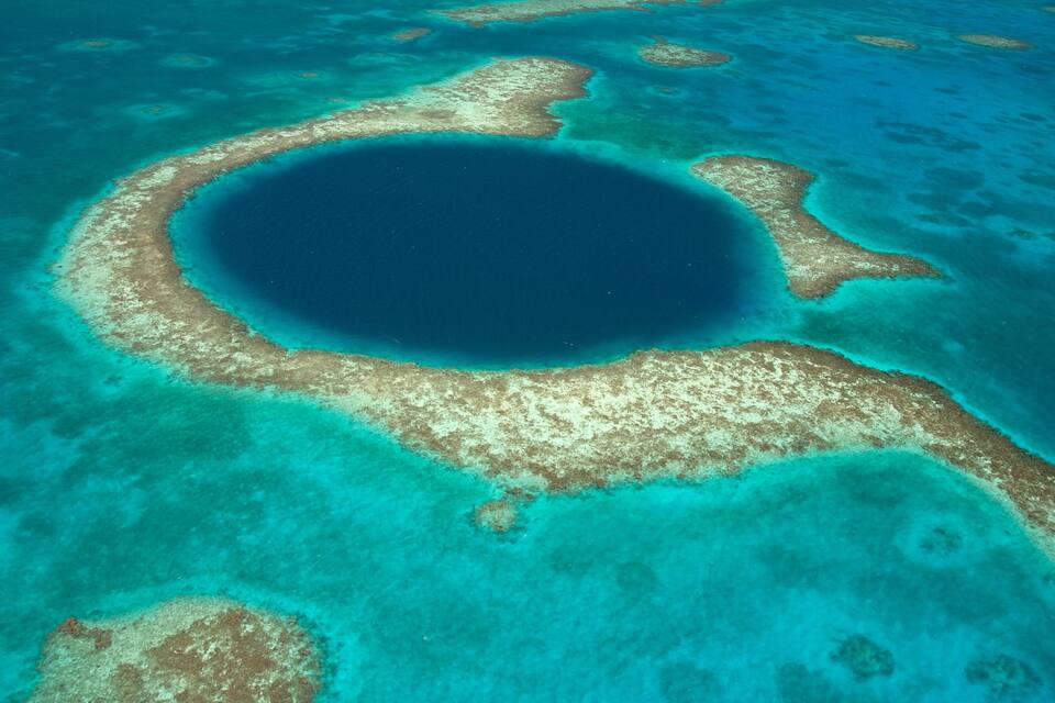 Une étendue d’eau d’un bleu limpide, bordée de récifs coralliens.