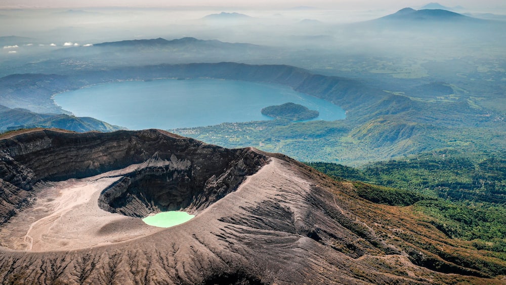 Aerial view of Santa Ana Volcano with lake and mountain cloud backdrop