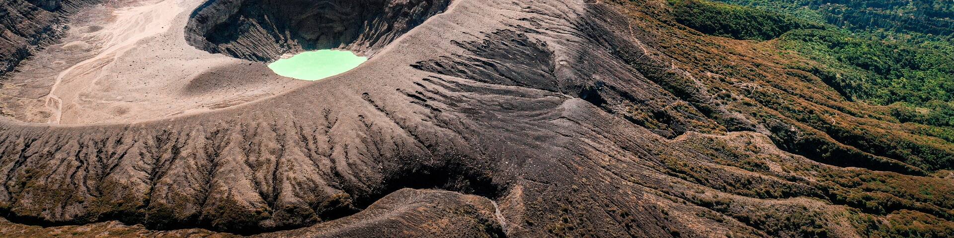 Aerial view of Santa Ana Volcano with lake and mountain cloud backdrop