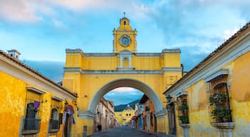 The Santa Catalina arch and the main street of Antigua city at sunrise, Guatemala.