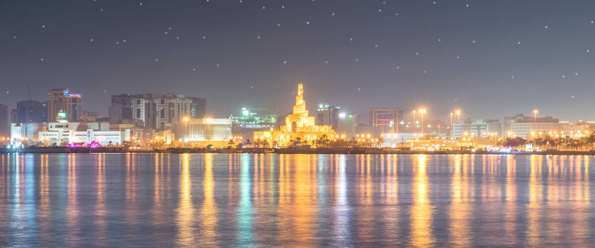 Abdulla Bin Zaid Al Mahmoud Islamic Cultural Center which includes night scenes, a city and a bay or harbor