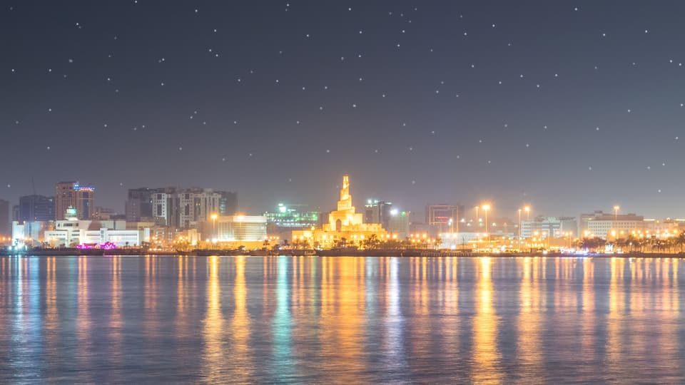 Abdulla Bin Zaid Al Mahmoud Islamic Cultural Center which includes night scenes, a city and a bay or harbor