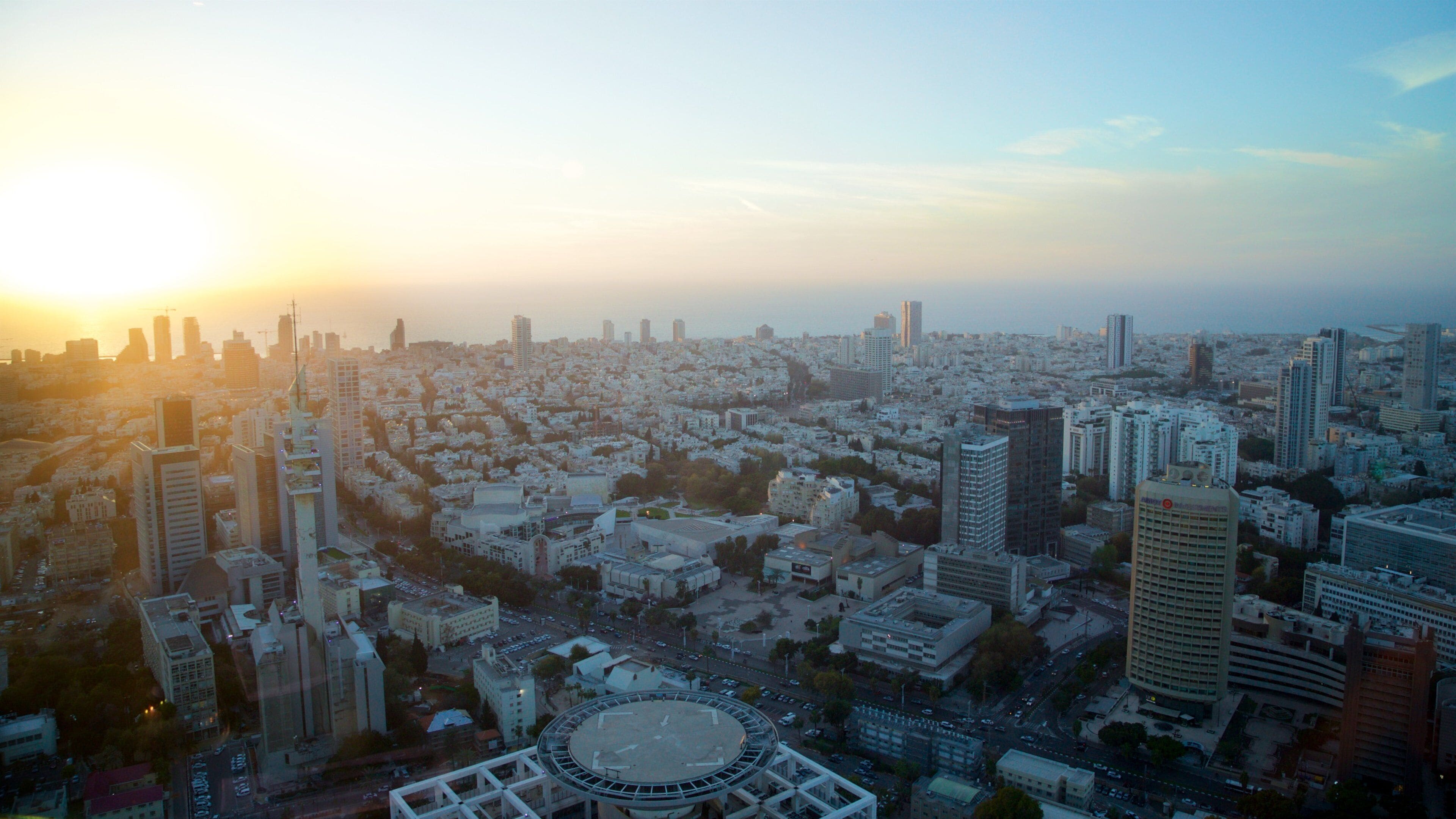 Azrieli Observatory showing a city, a sunset and landscape views