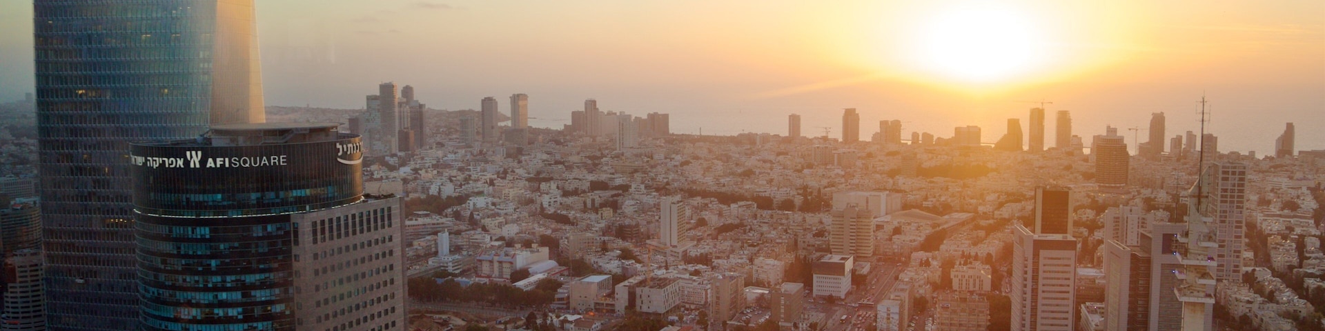 Azrieli Observatory showing a skyscraper, a sunset and landscape views