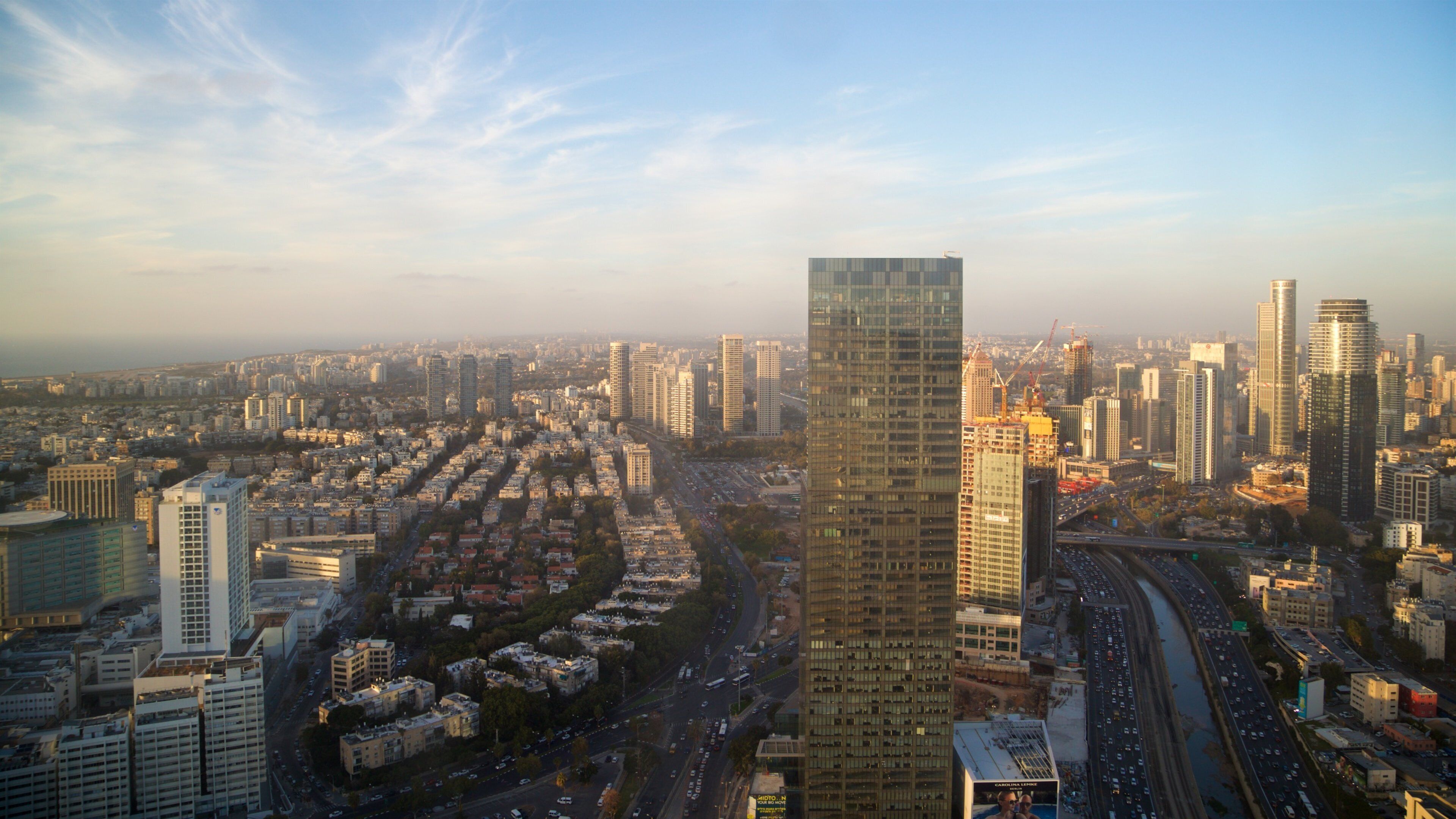Azrieli Observatory featuring a skyscraper, a sunset and landscape views