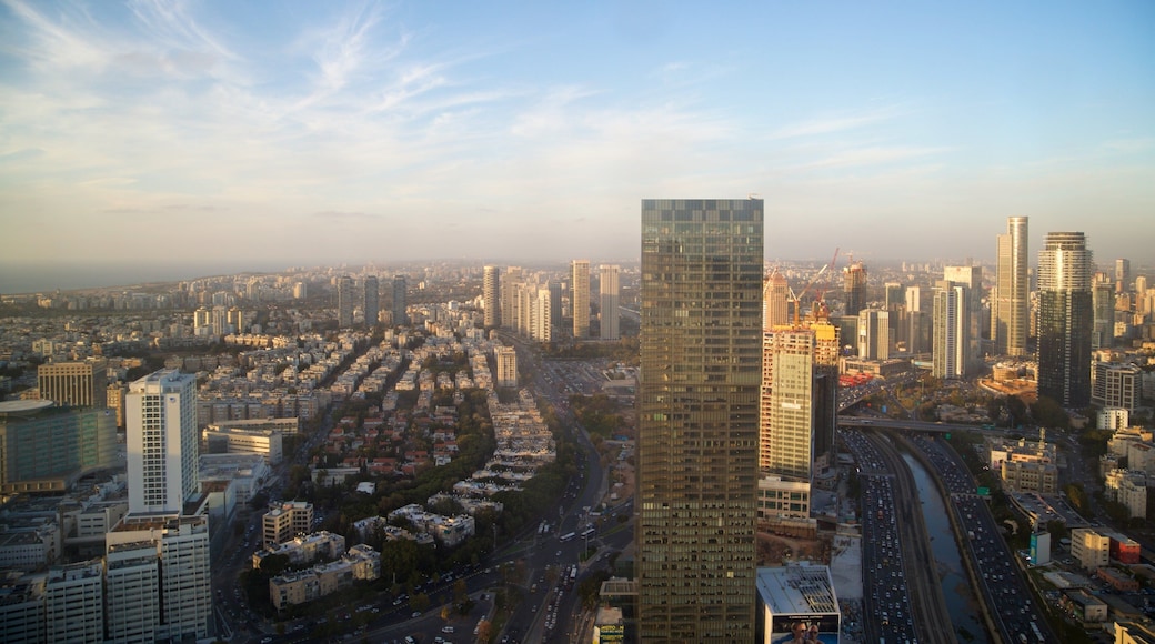 Azrieli Observatory featuring a skyscraper, a sunset and landscape views