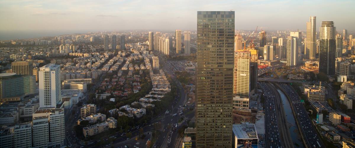 Azrieli Observatory featuring a skyscraper, a sunset and landscape views