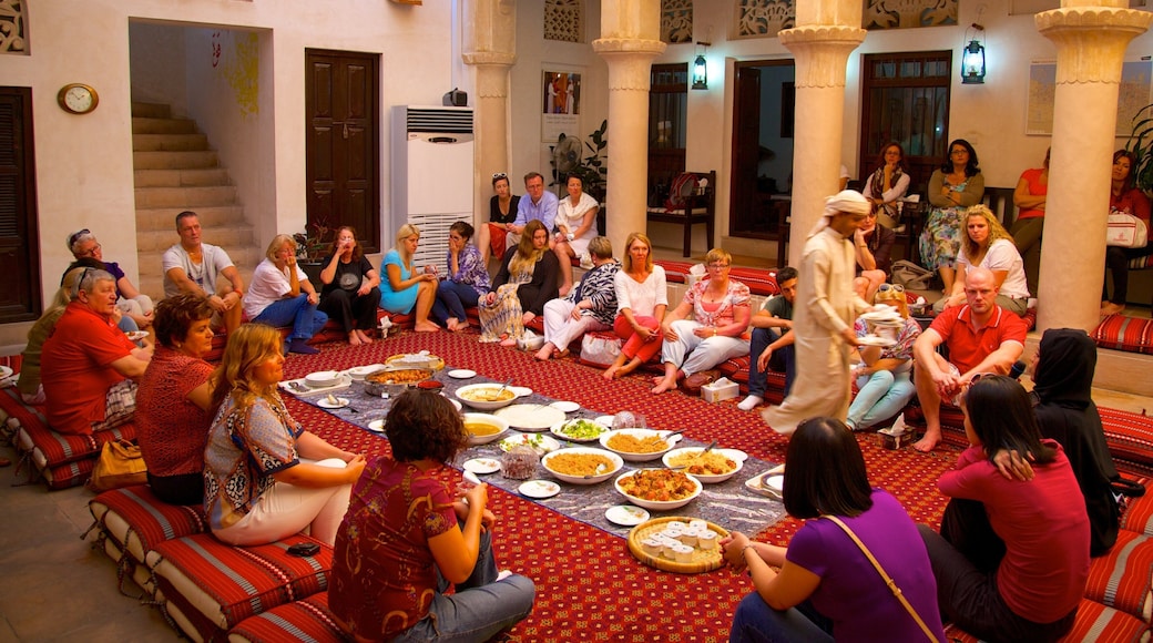 Dubai Emirate showing food and interior views as well as a large group of people