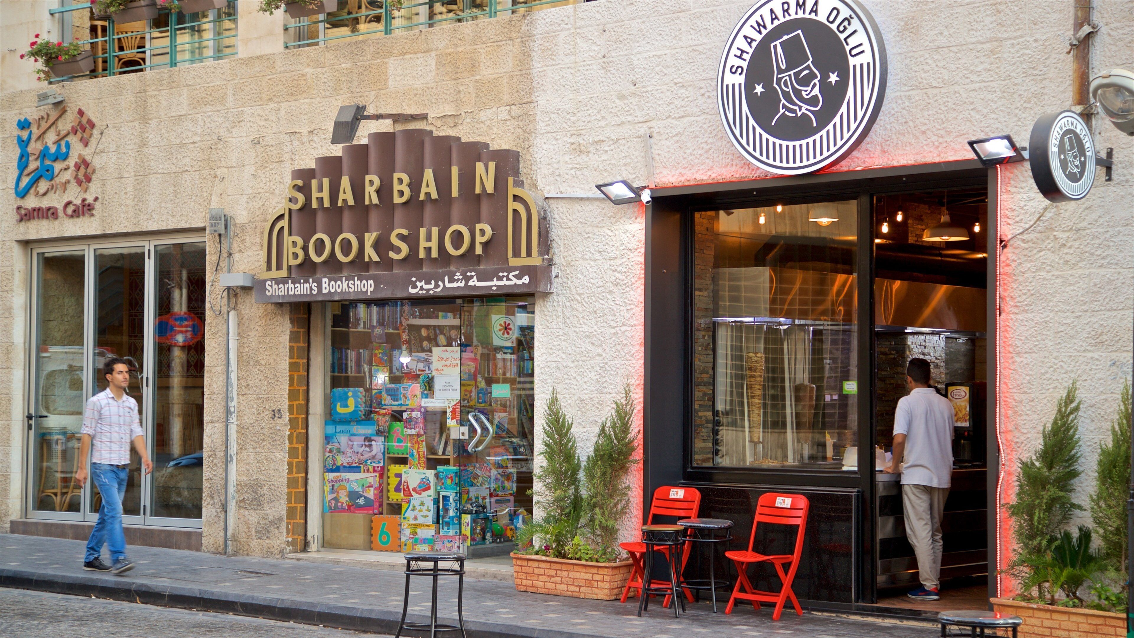 Rainbow Street featuring street scenes and signage as well as an individual male