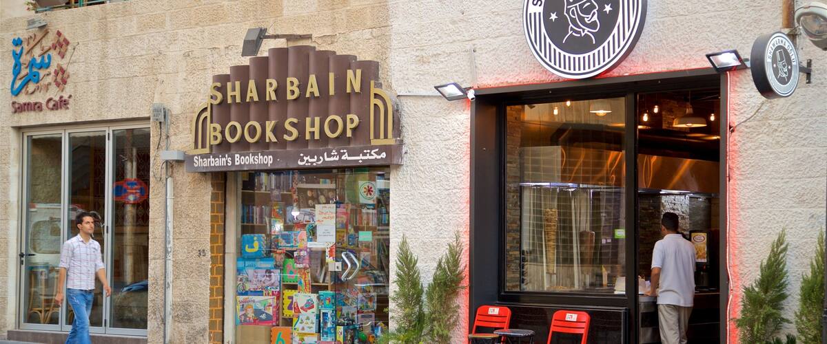 Rainbow Street featuring street scenes and signage as well as an individual male