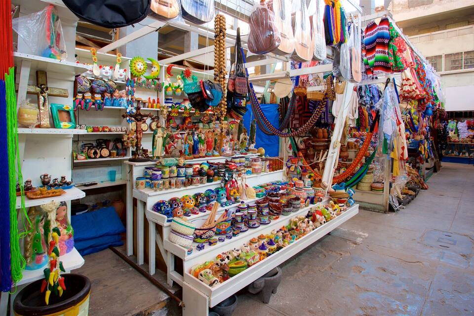 A vibrant market stall with colorful textiles, ceramics, and various handicrafts.